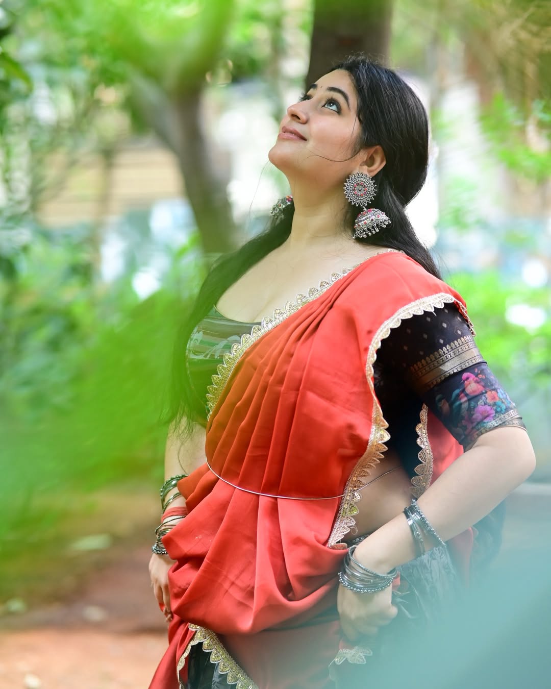 Bold K Sudha Flaunting Long Dark Wavy Tresses.