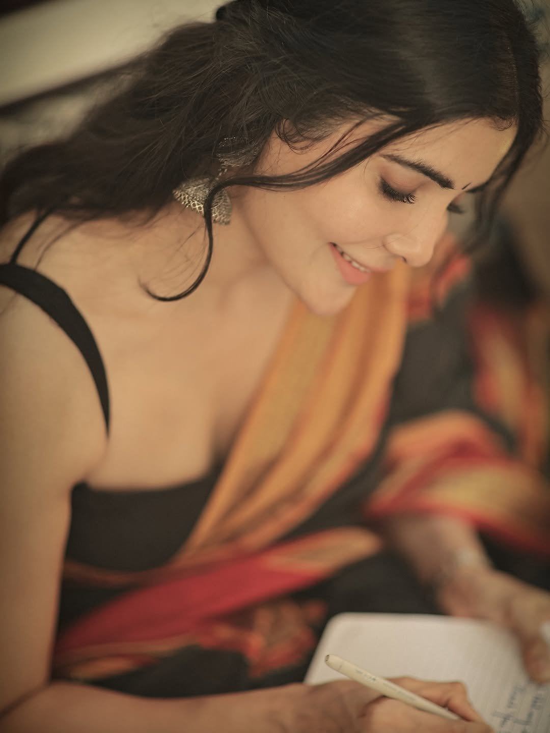 Madhuri Jain Writing In Book With Playful Smile!