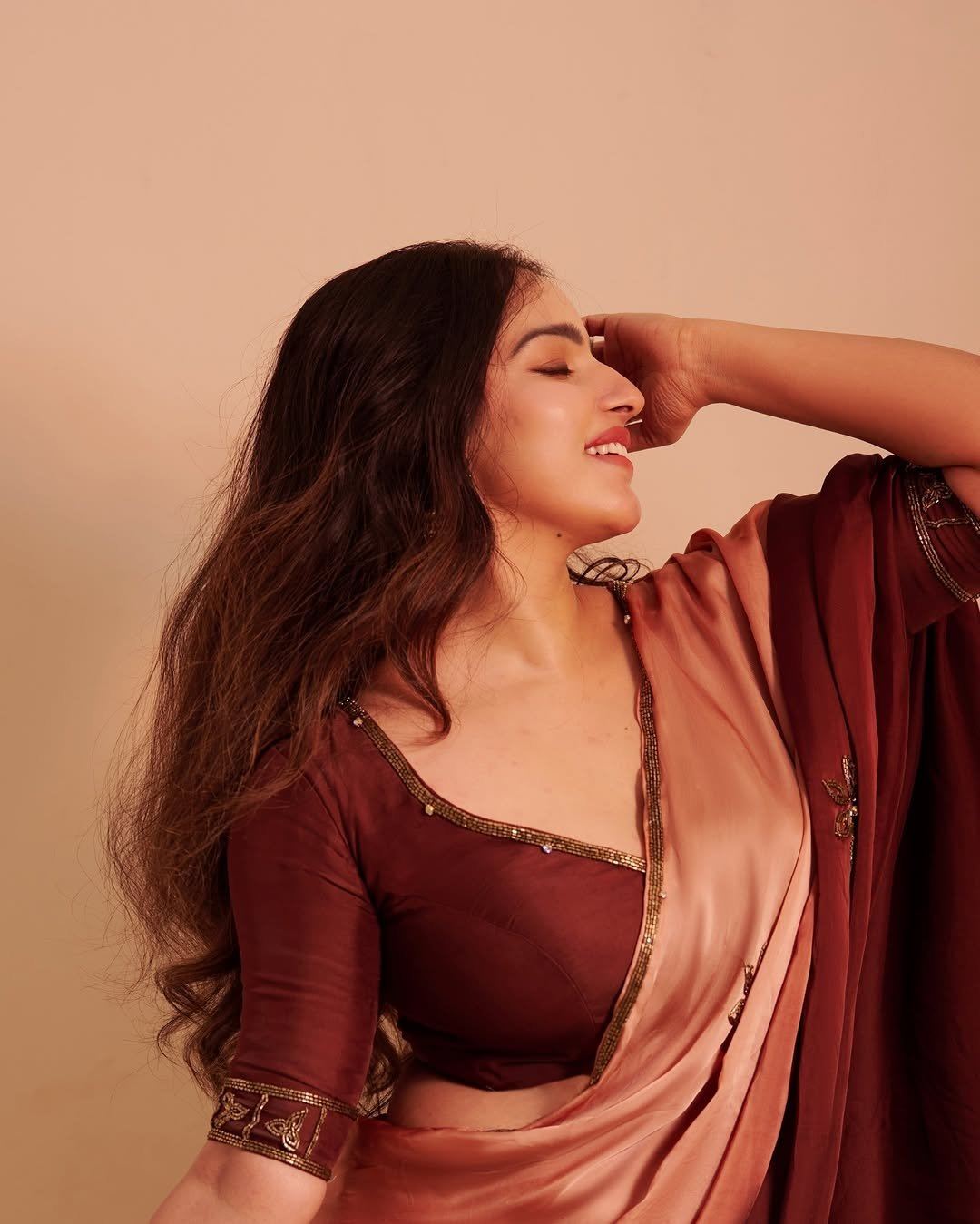 Malavika Menon Playful Expression In Maroon Saree