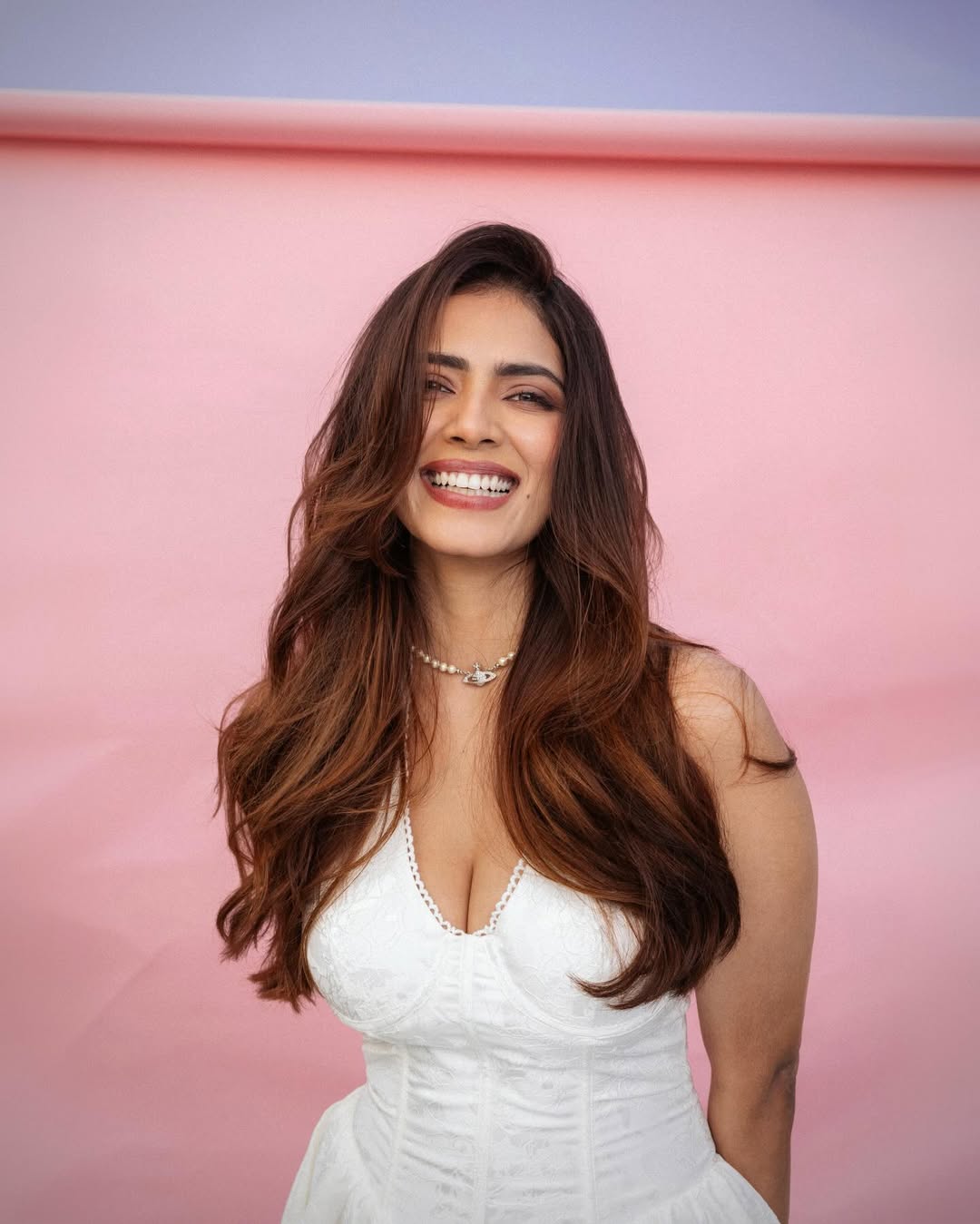 Malavika Mohanan Posing In Bold White Halter Fit