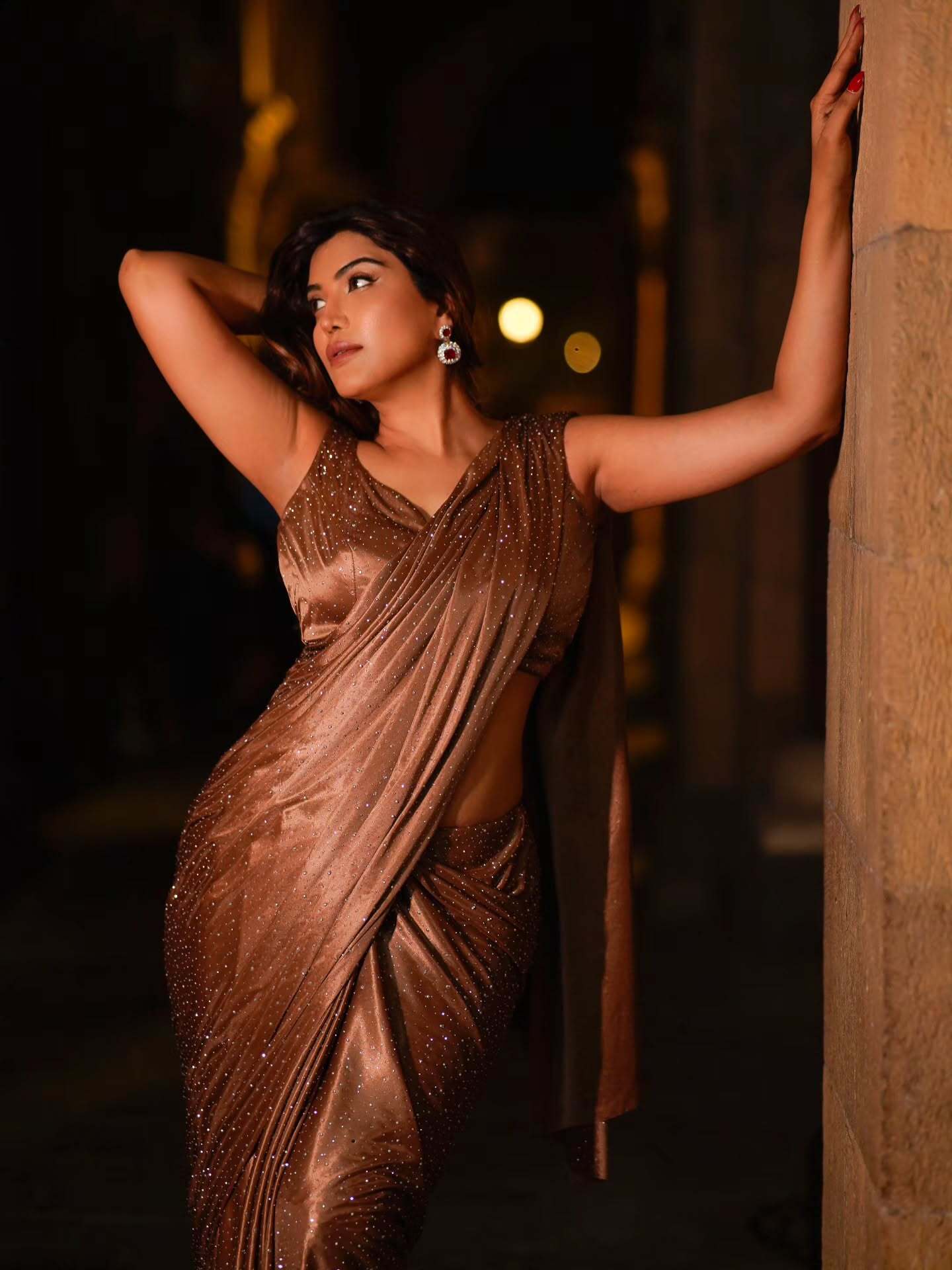 Mrinmai Kolwalkar posing in shimmering brown saree