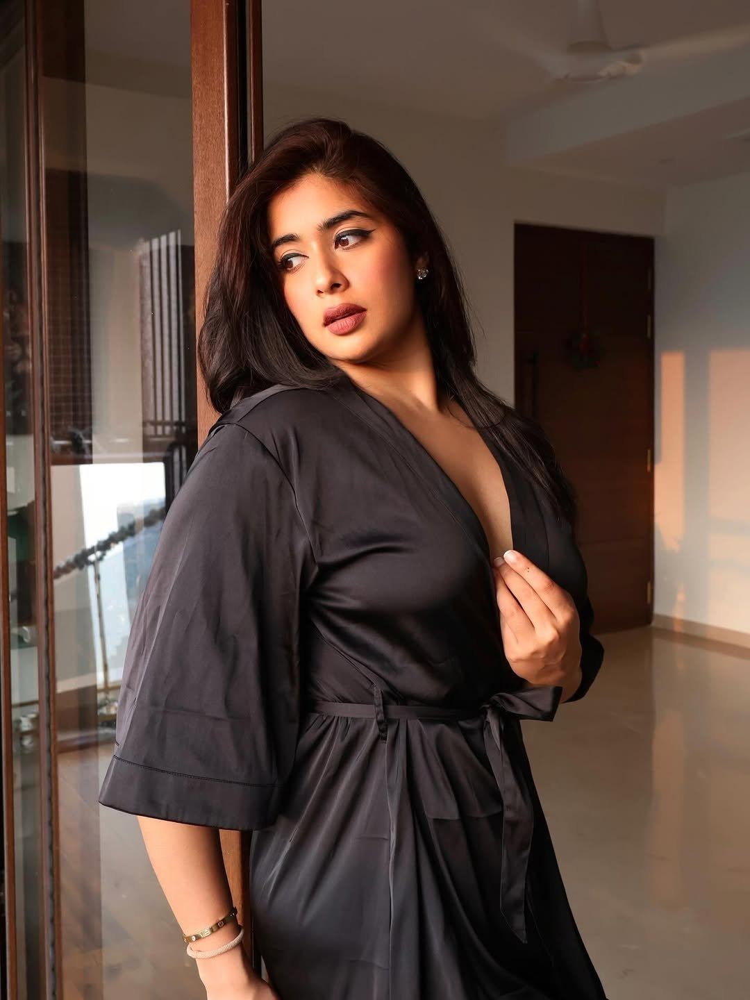 Nikita Sharma Poses In Her Black Satin Robe Style