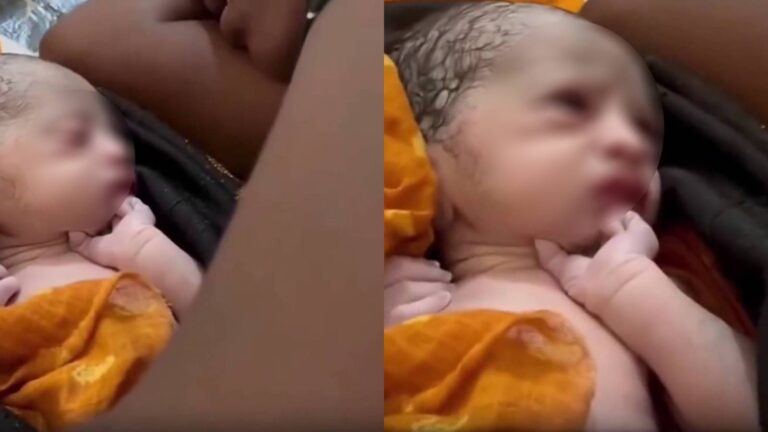 Mother turning away from newborn baby