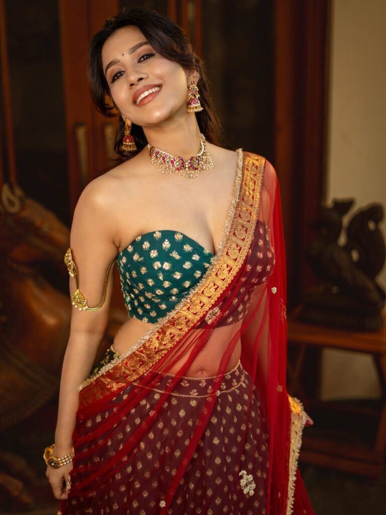 Nabha Natesh in red saree with green blouse and temple jewellery