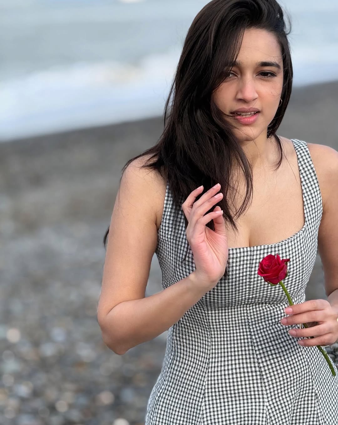 Nuveksha Smiling Softly With Red Rose