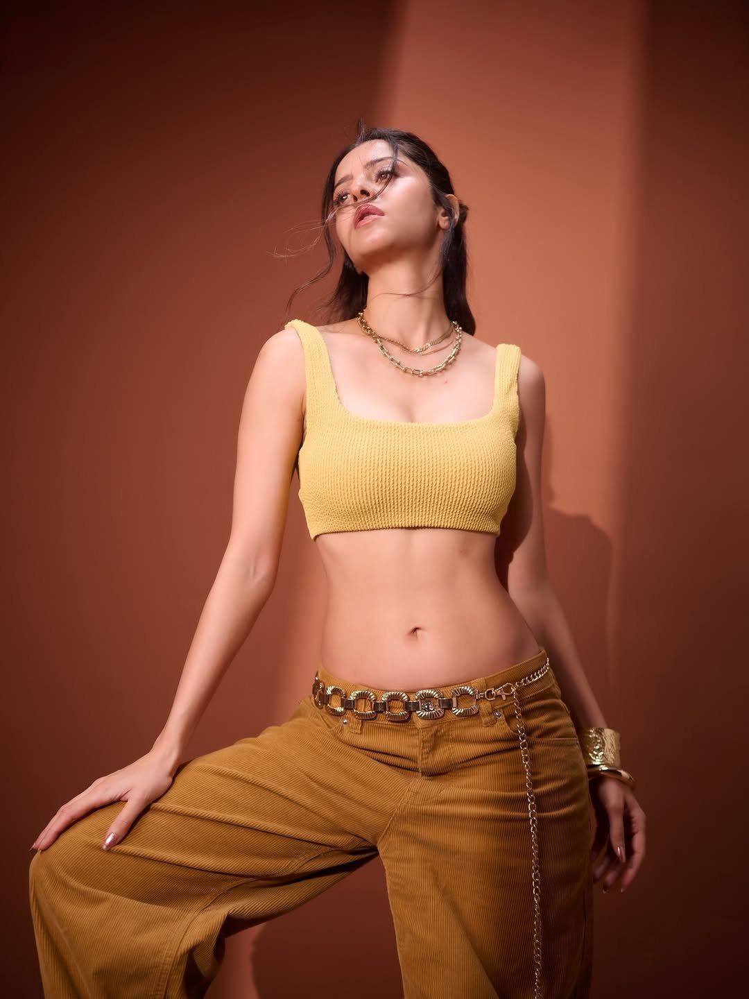Vedhika Flaunts Her Fit Toned Midriff In Yellow.