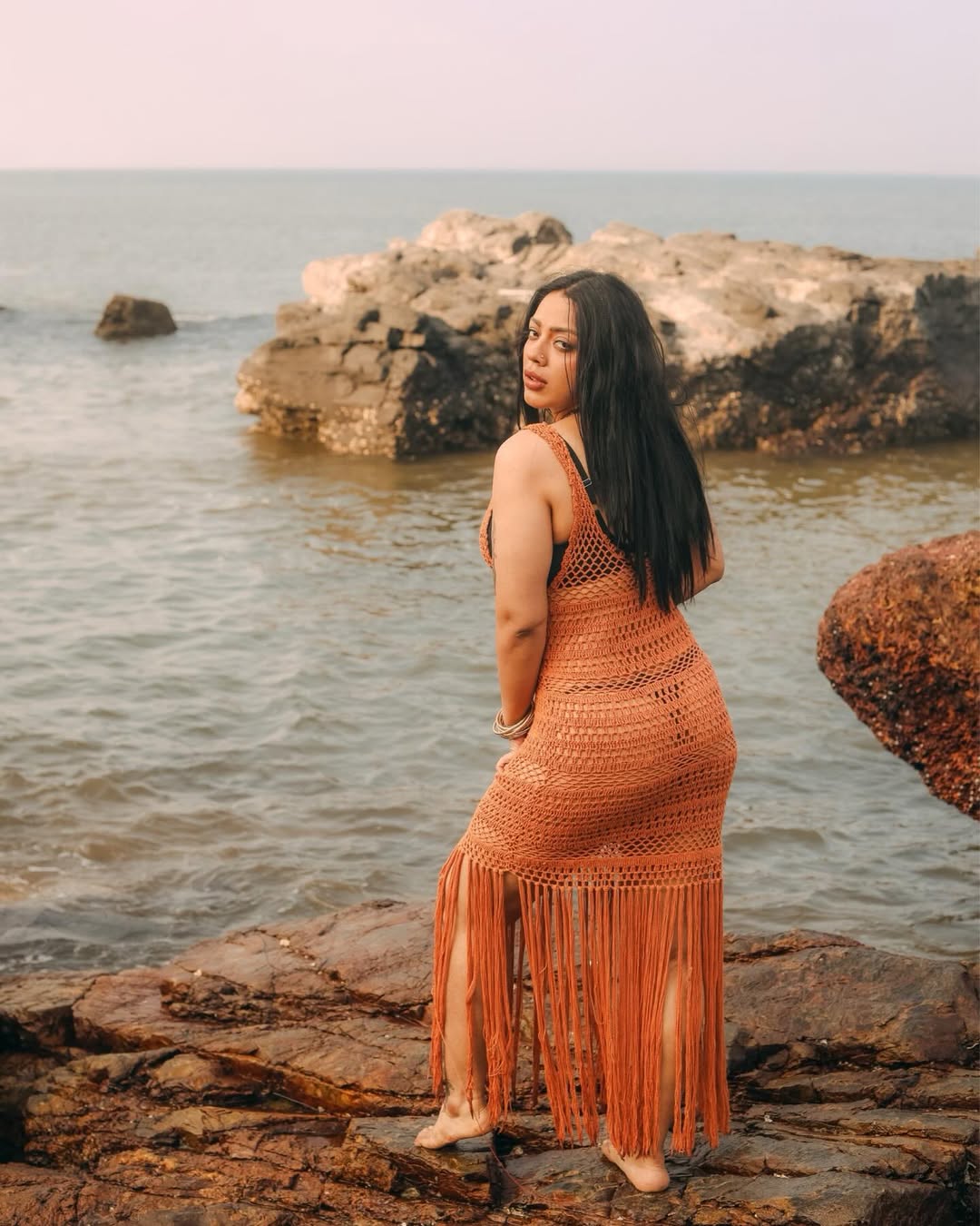 Deviyani Sharma Posing On Shoreline Rocks