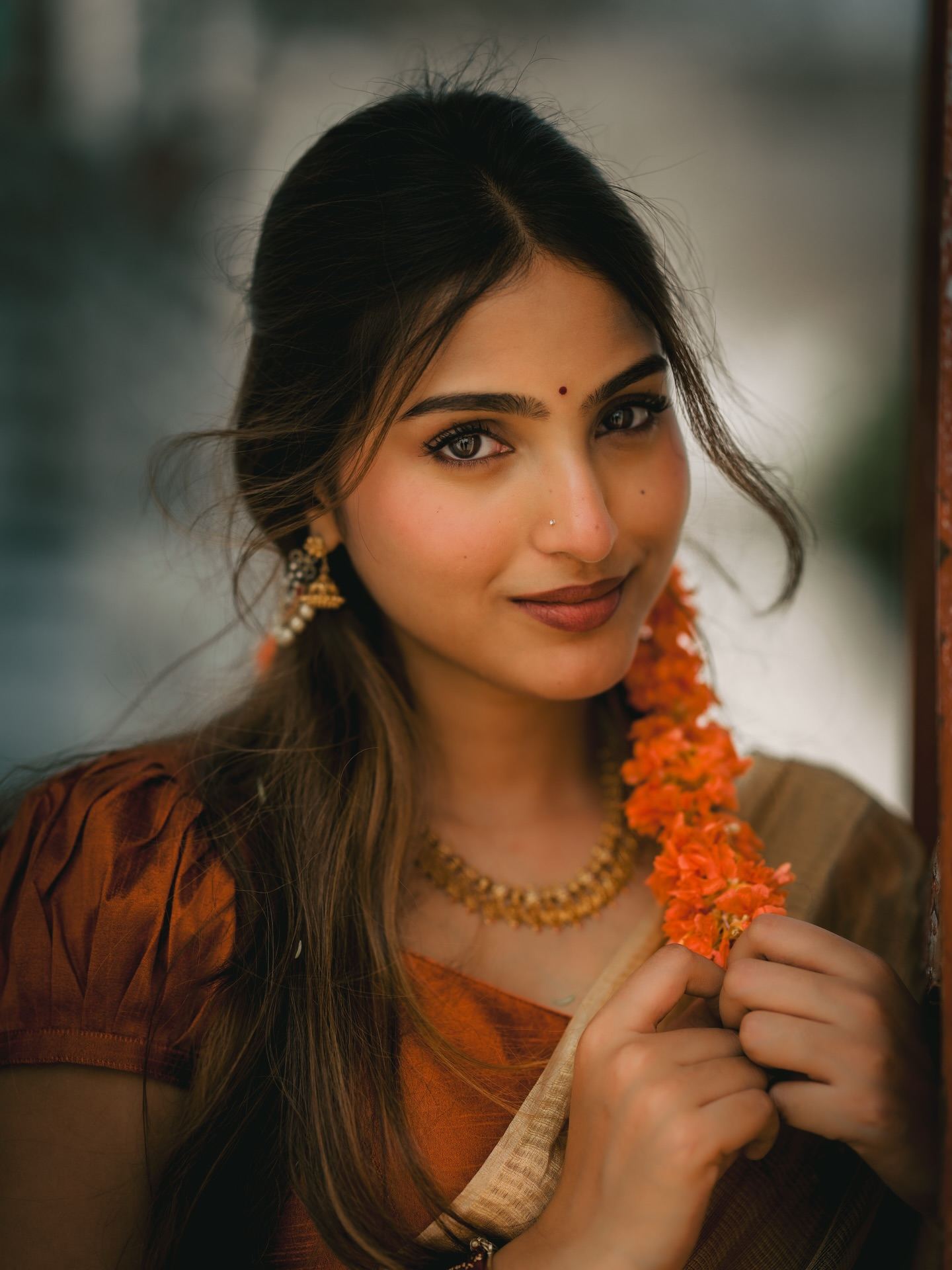 Pranavi Smiling Over Shoulder With Flower Garland