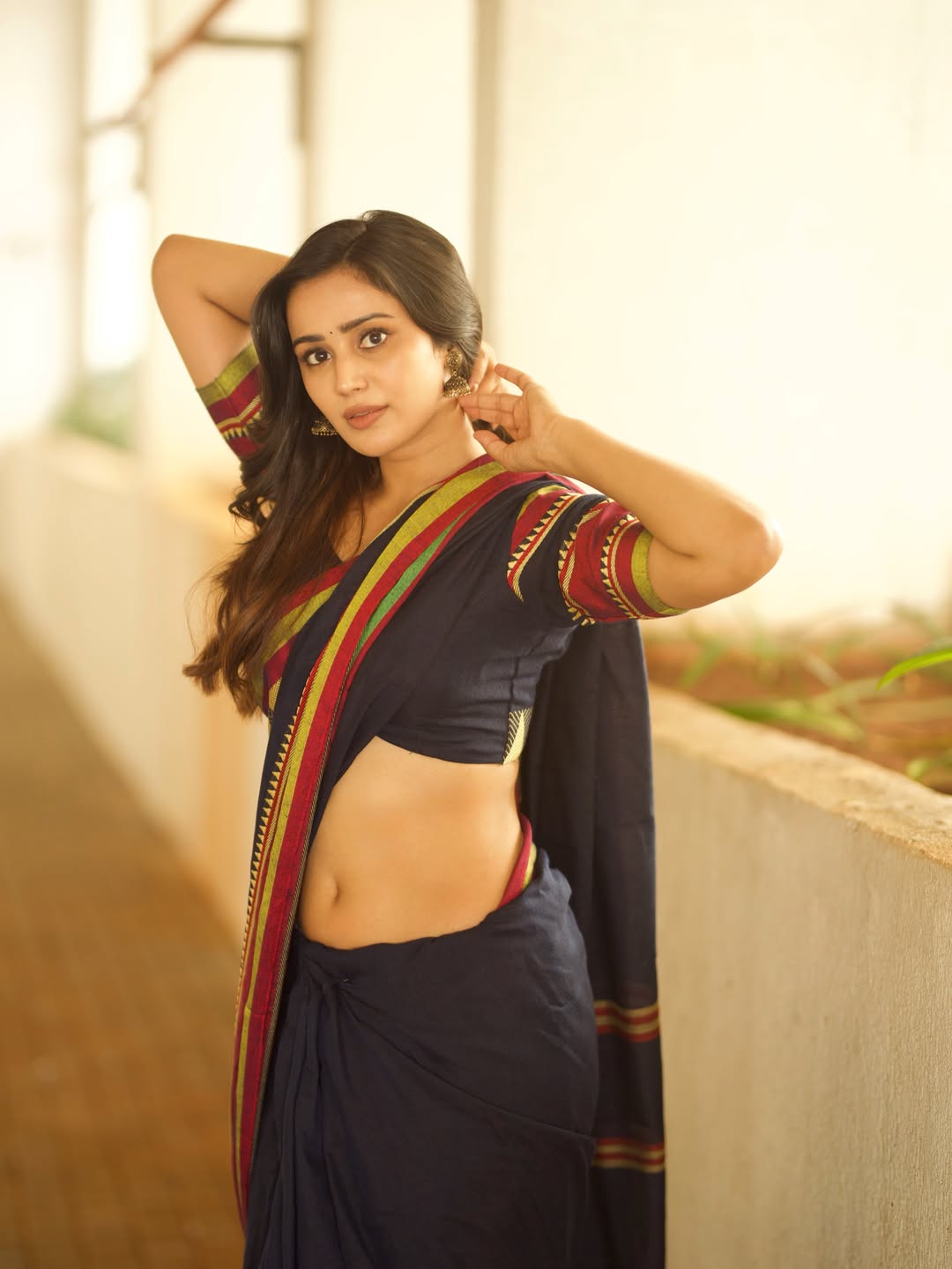 Anaira Gupta Raising Arms Up In Balcony Portrait