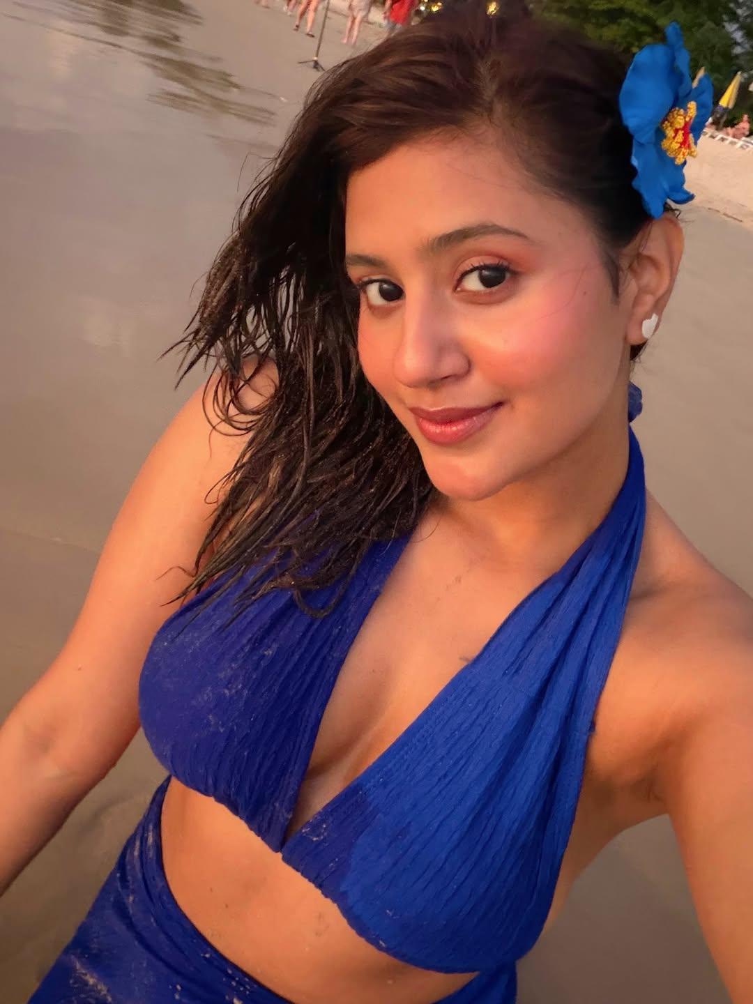 Anjali Arora With Blue Flower In Hair On Shore