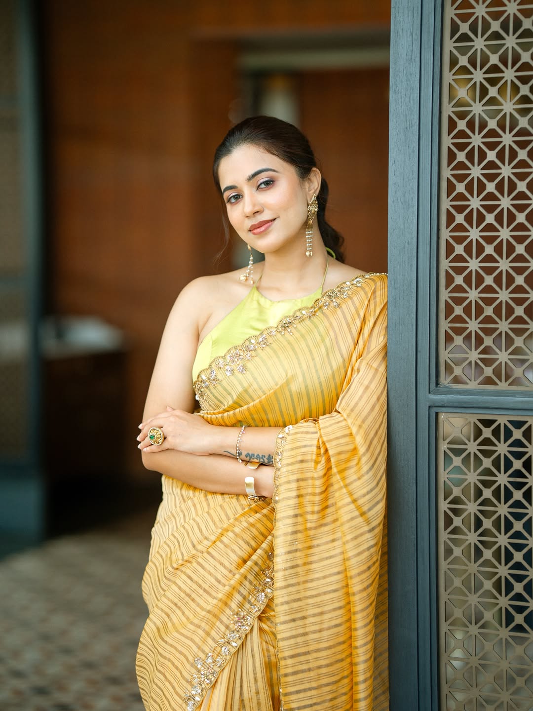 Anju Kurian Leaning Gracefully In Yellow Saree