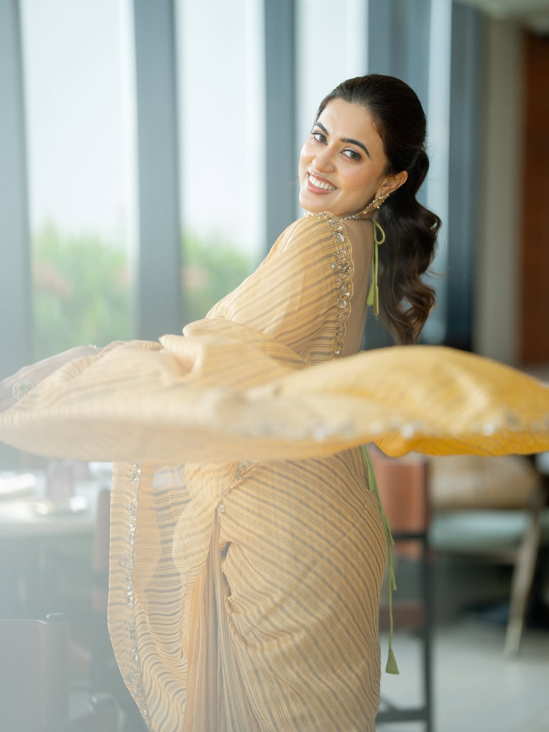 Playful Anju Kurian Twirling In Striped Saree