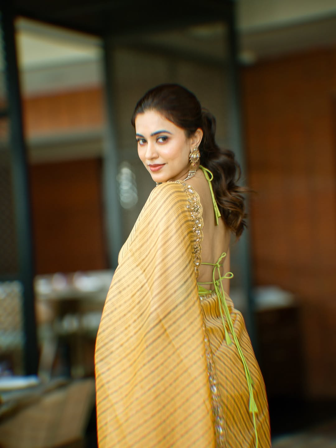 Anju Kurian Looking Over Shoulder In Edgy Blouse