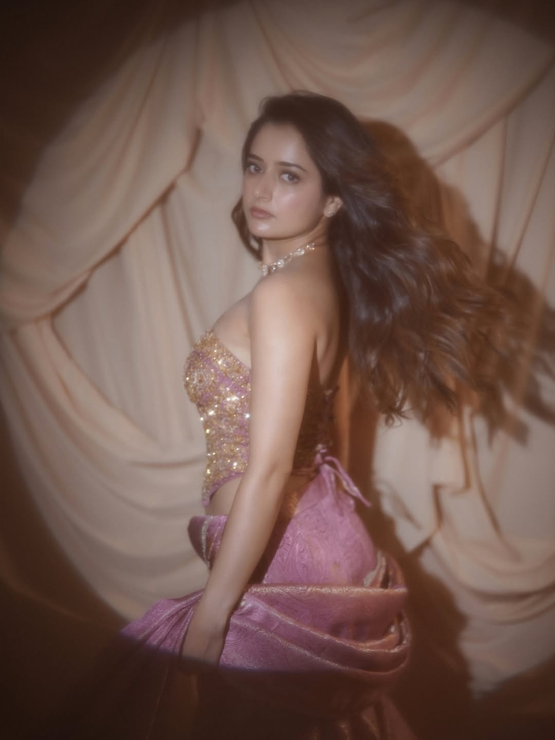 Ashika Ranganath Turning Around Dramatic Pose Pic