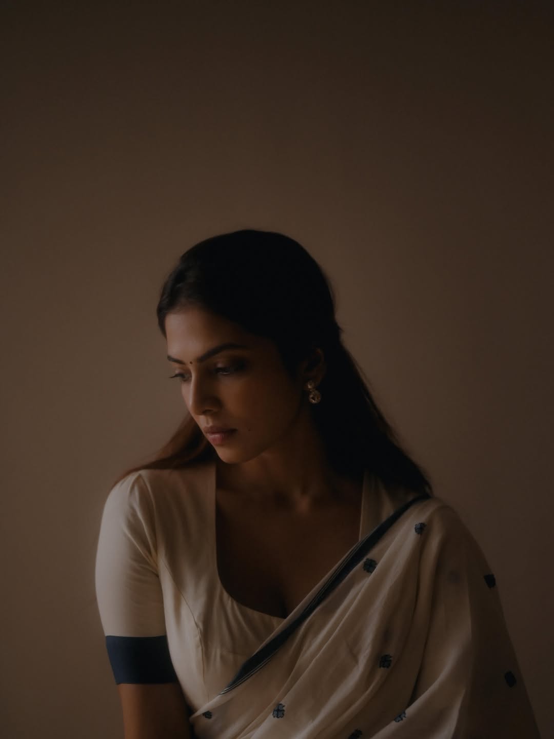 Malavika Mohanan Looking Down In White Saree