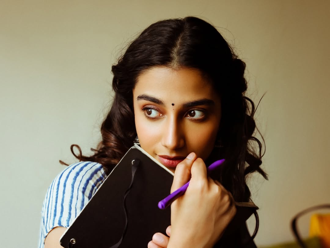 Meenakshi Chaudhary Holding Notebook Close To Face