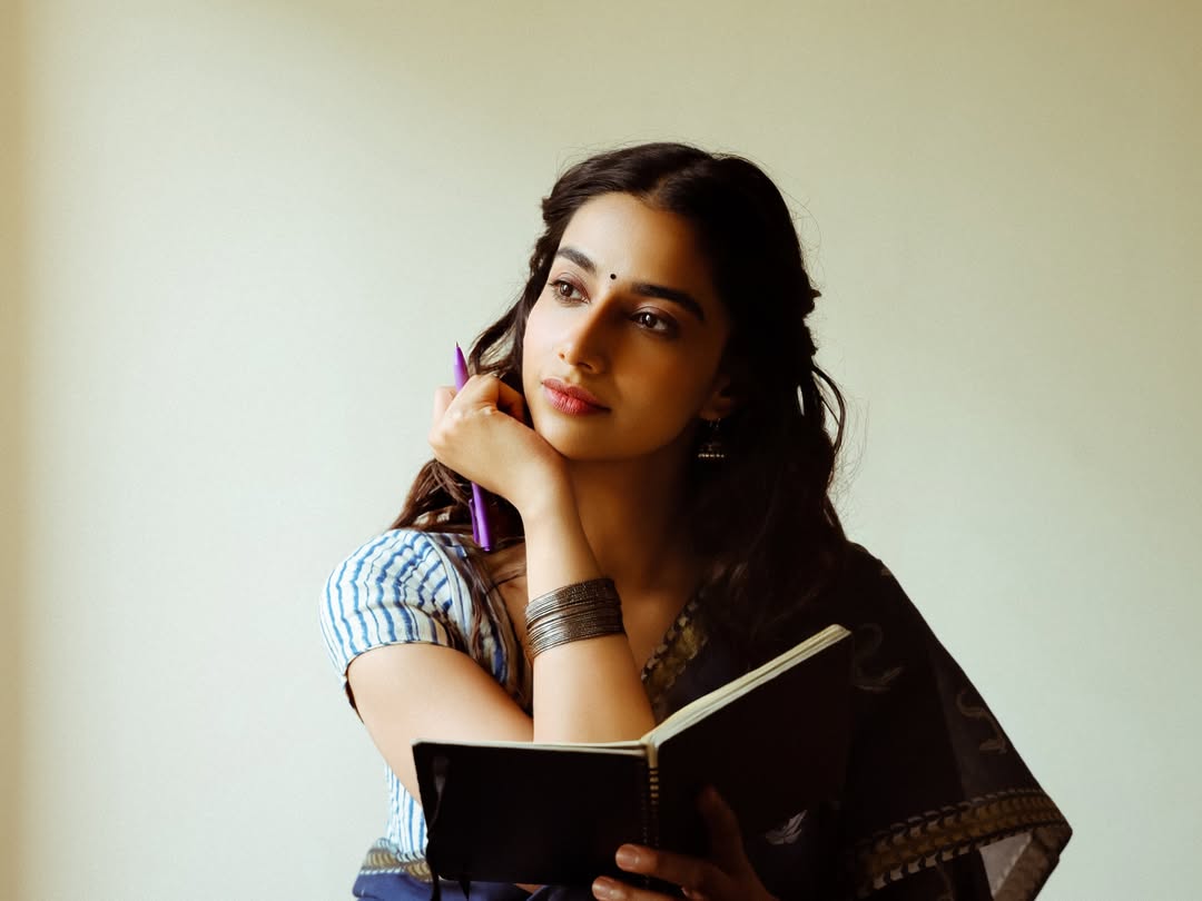 Meenakshi Chaudhary Holding Purple Pen Over Notebook