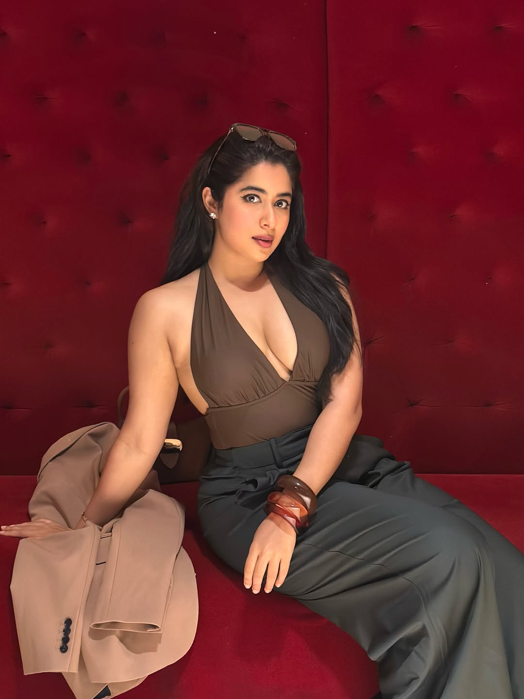 Nikita Sharma Flaunts Bold Pose On Red Couch