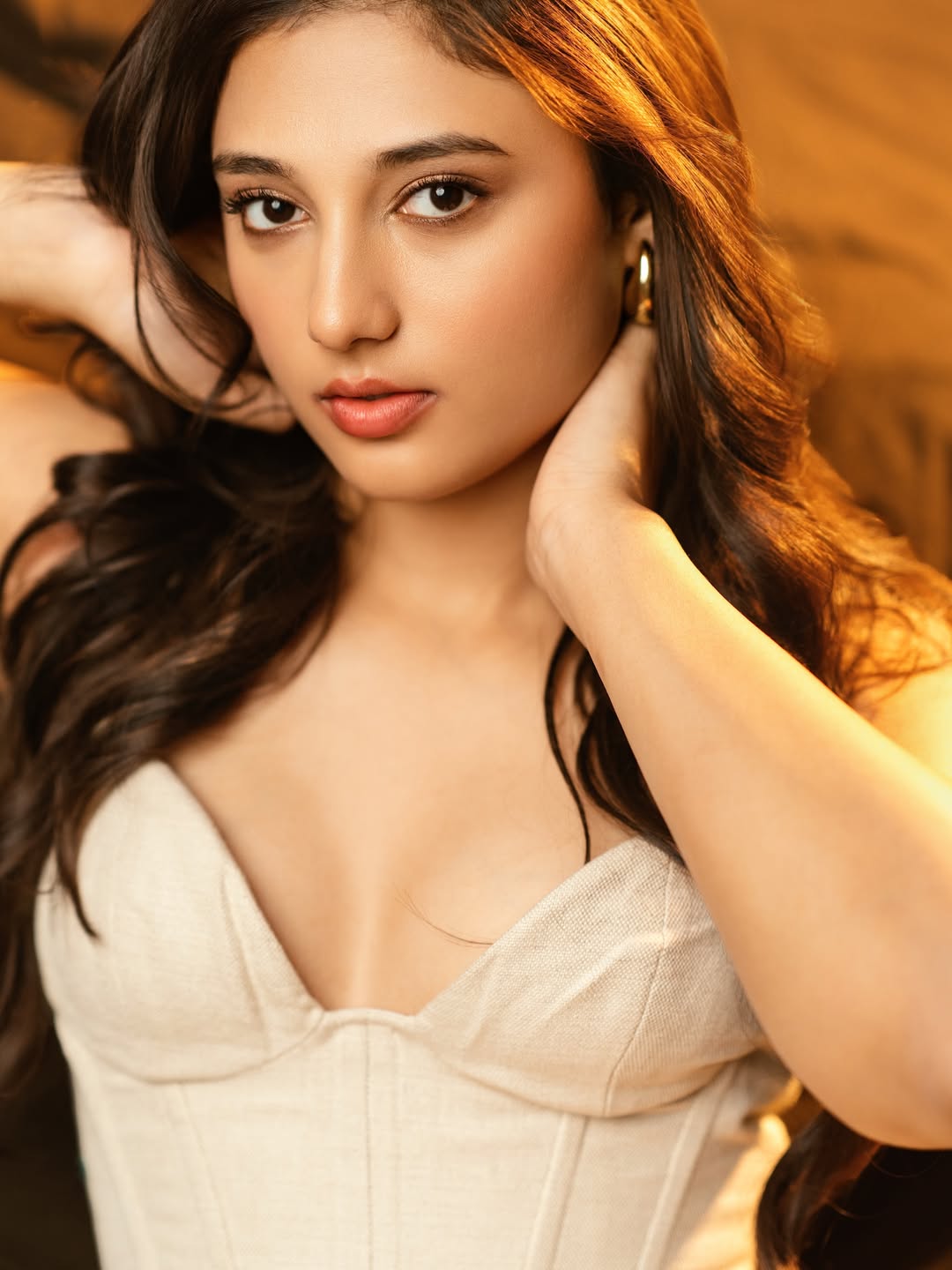 Ritika Nayak Sitting Confidently In White Dress