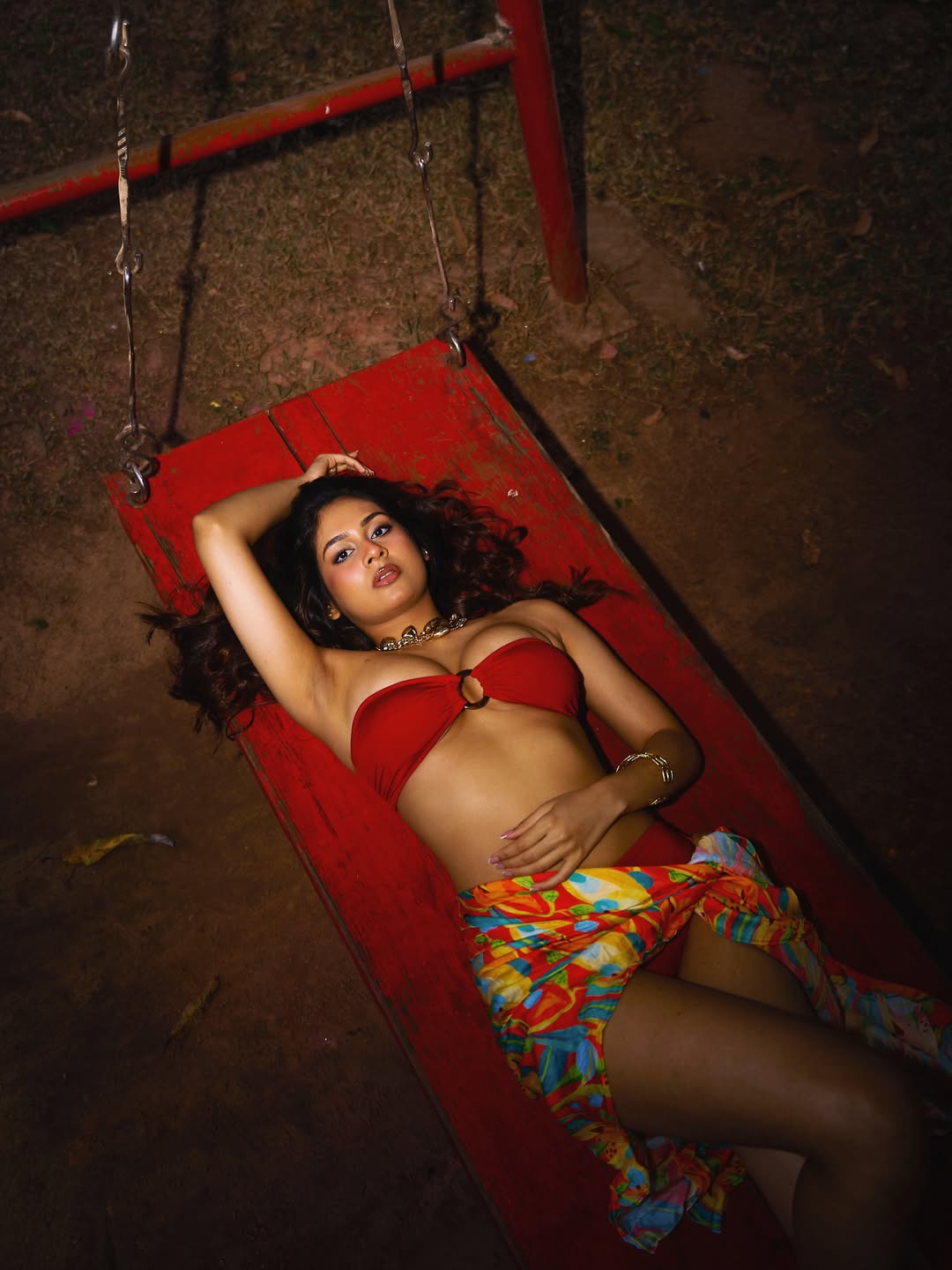 Srushti Bannatti Reclines On Red Wooden Swing