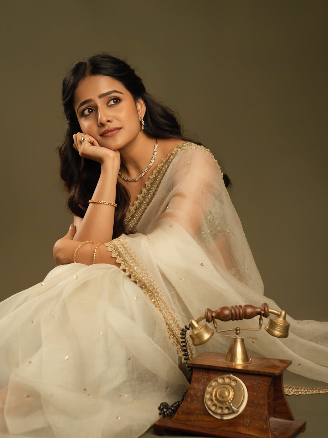 Vaishnavi Chaitanya Dreamy Sitting Pose With Phone
