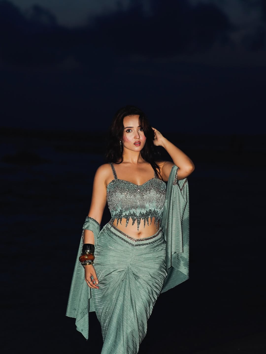 Varsha Rekhate Seated Gracefully On Dark Shore