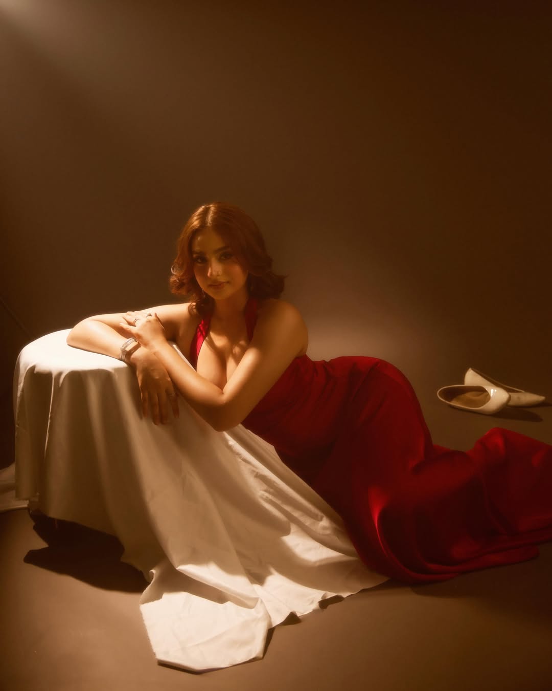 Ayesha Khan Reclining Gracefully In Crimson Attire
