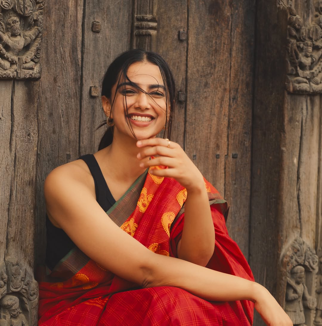 Meenakshi Chaudhary Radiant Smile In Red Drape