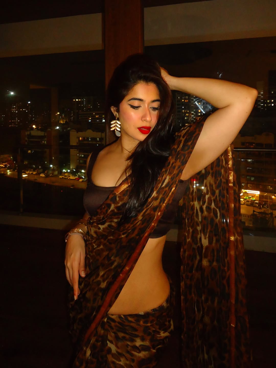 Nikita Sharma Posing Confidently Against Window