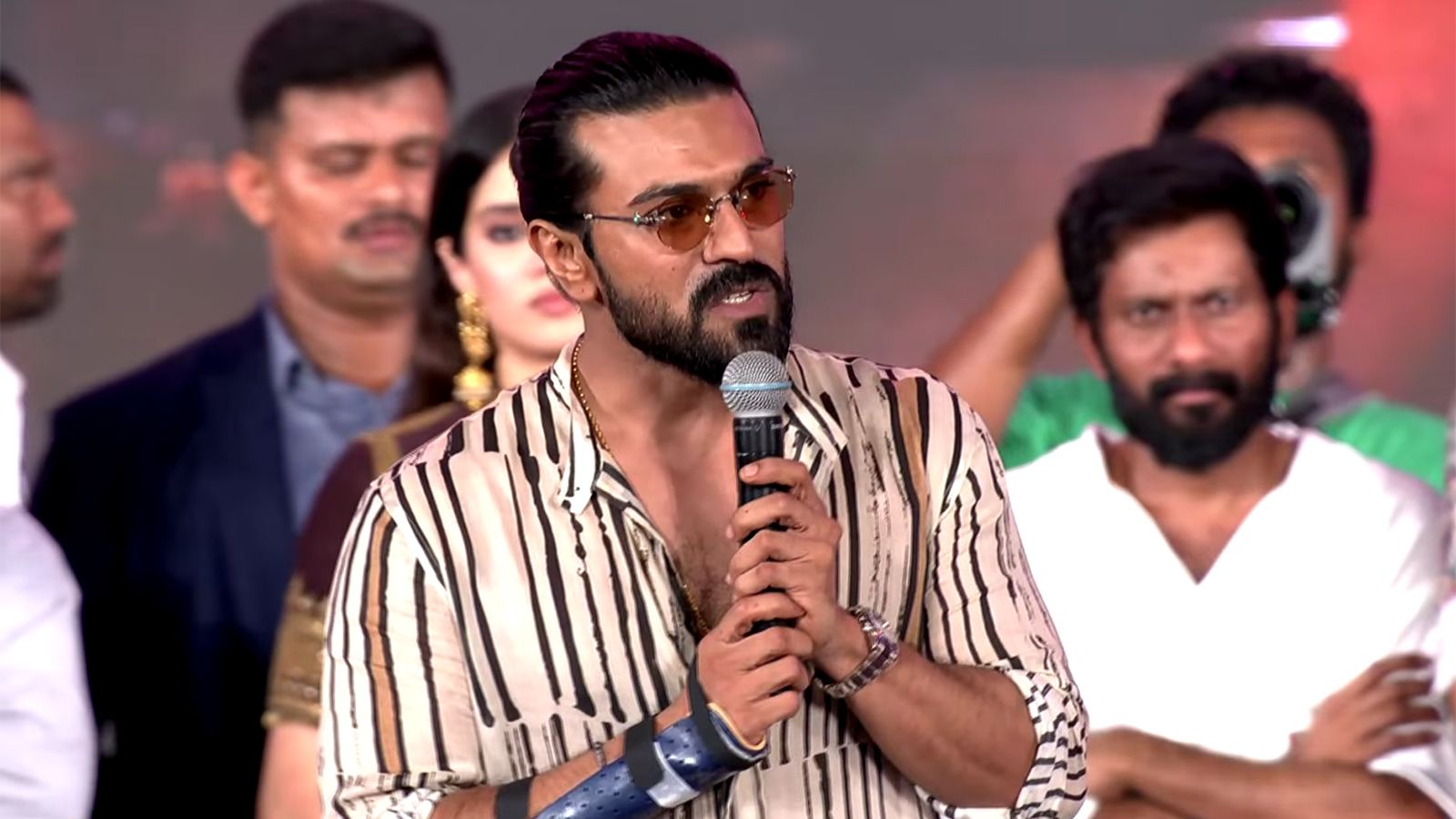Ram Charan at Peddi pre-release event stage