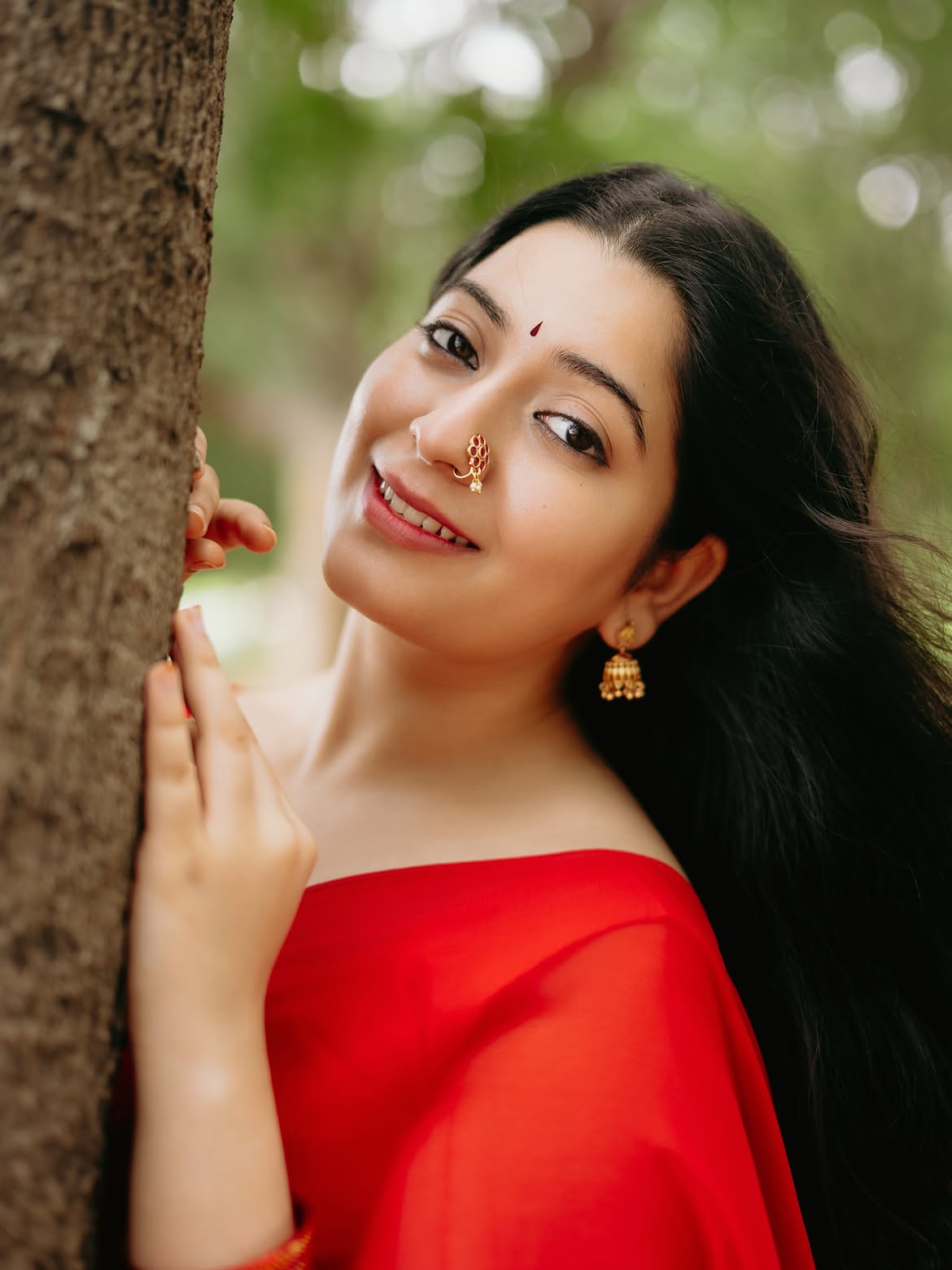 K Sudha Smiling Warmly Wearing Gold Nose Ring