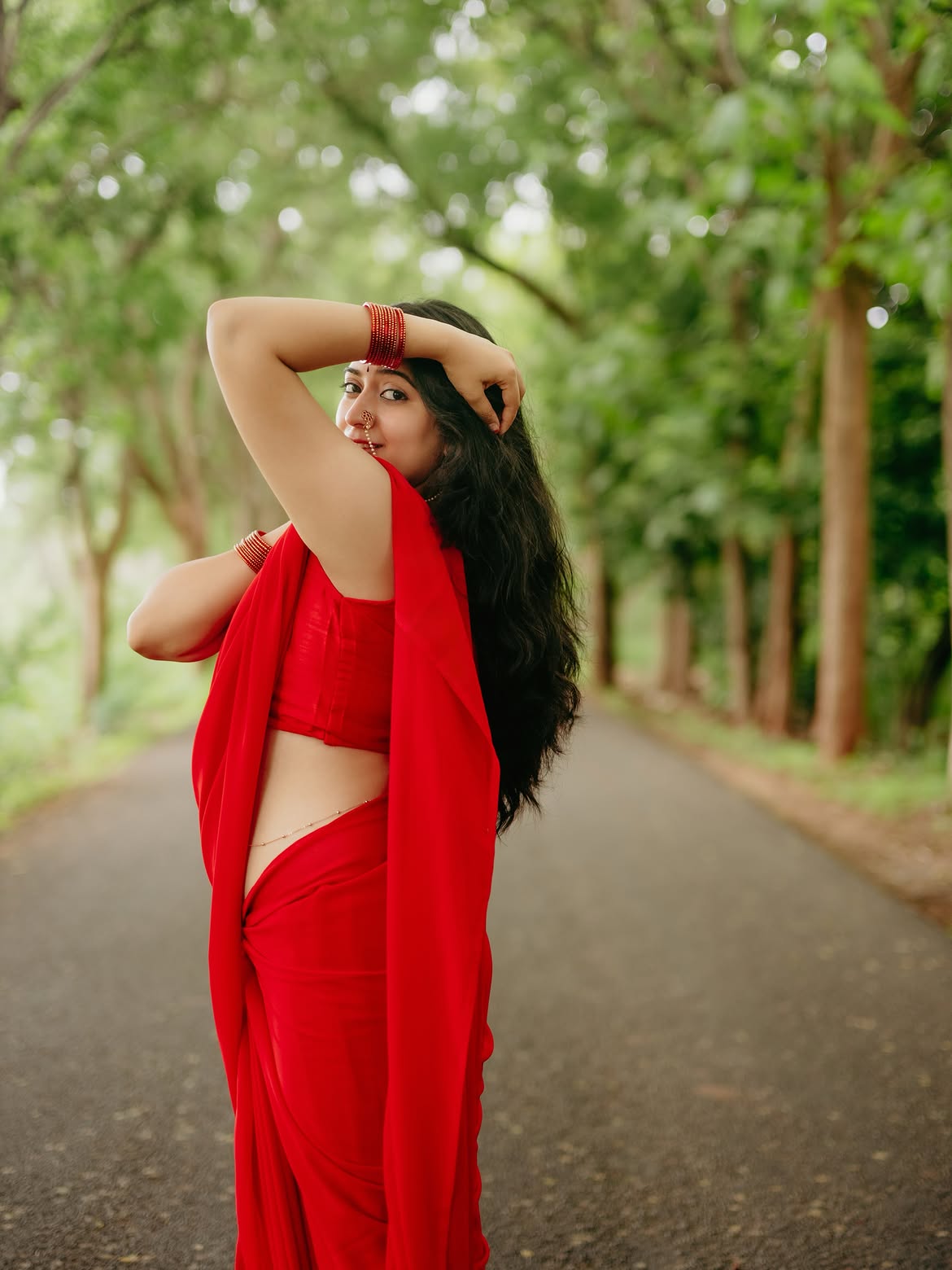 K Sudha Showcasing Curves In Chiffon Red Saree