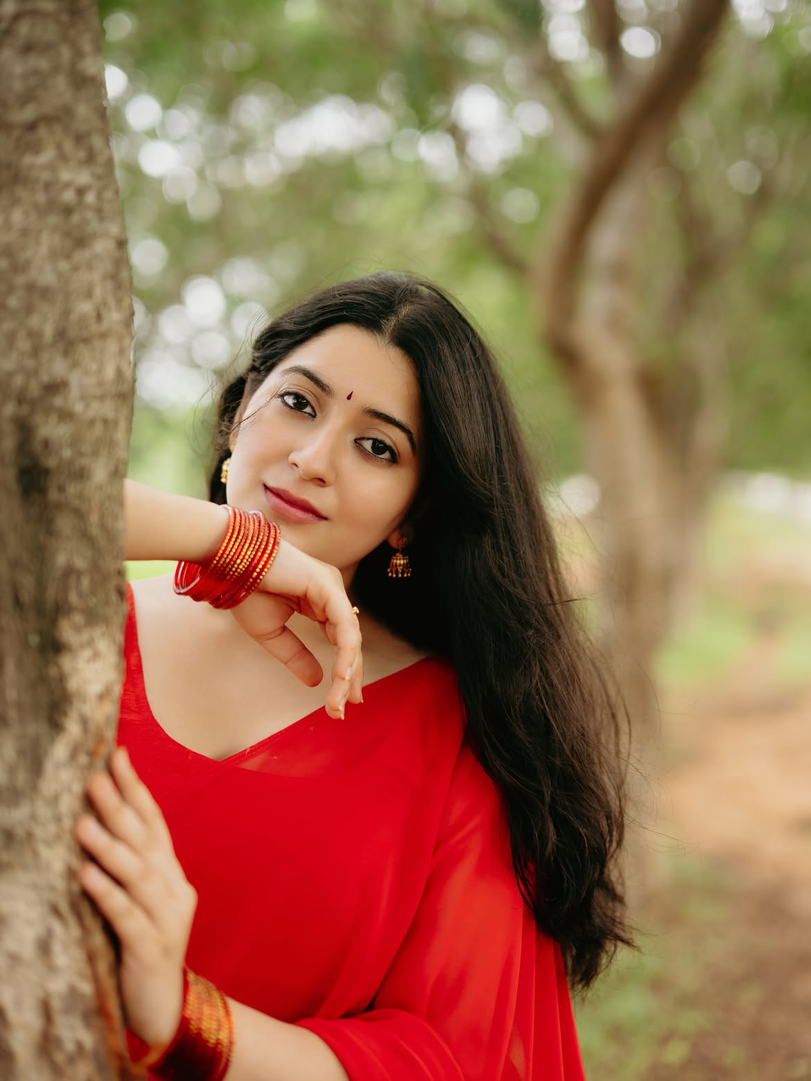 K Sudha Leaning On Tree Staring Boldly Ahead
