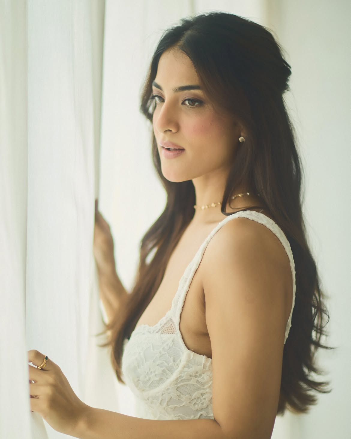 Miloni Jhonsa Standing Gracefully By White Curtain