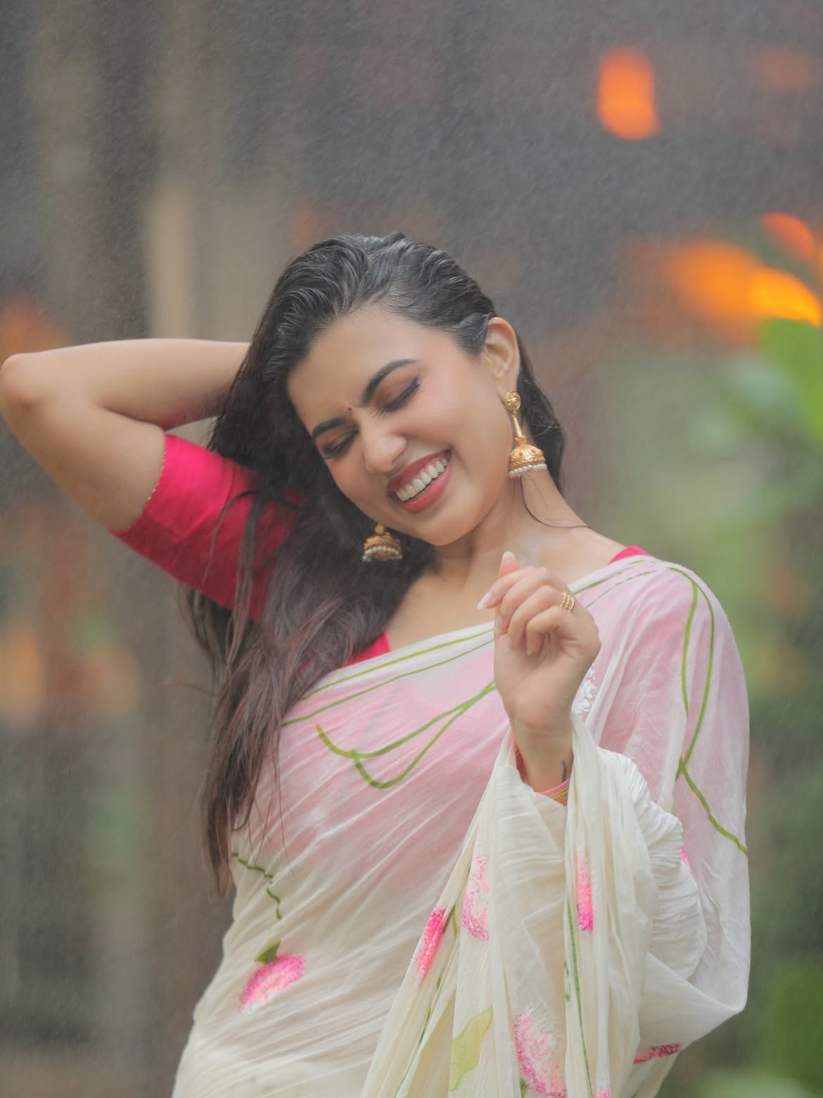 Anju Kurian Smiles In Rain Wearing Floral Saree