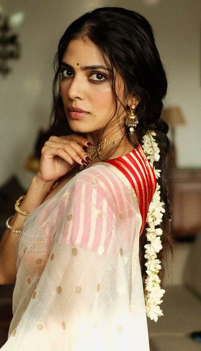 Malavika Mohanan Elegant Floor Pose With Lotus
