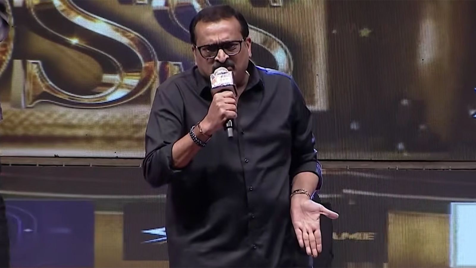 Crowd cheering at a Telugu film event