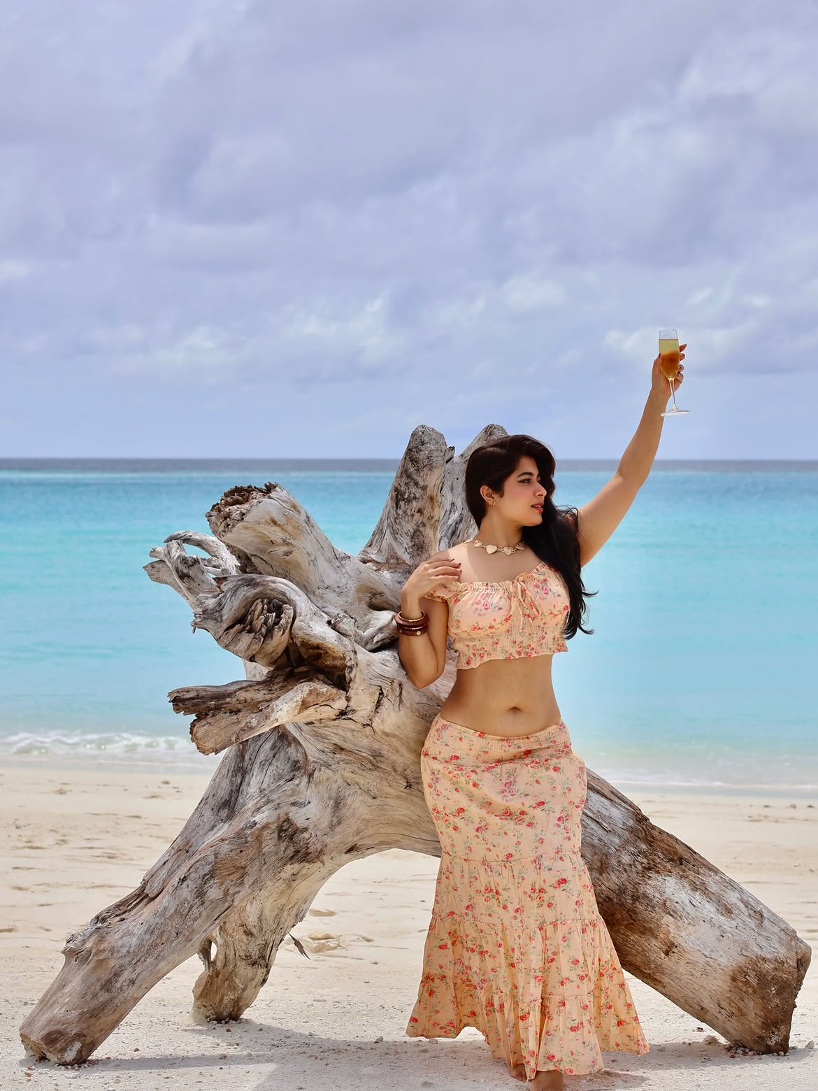 Nikita Sharma Poses By Driftwood In Floral Style
