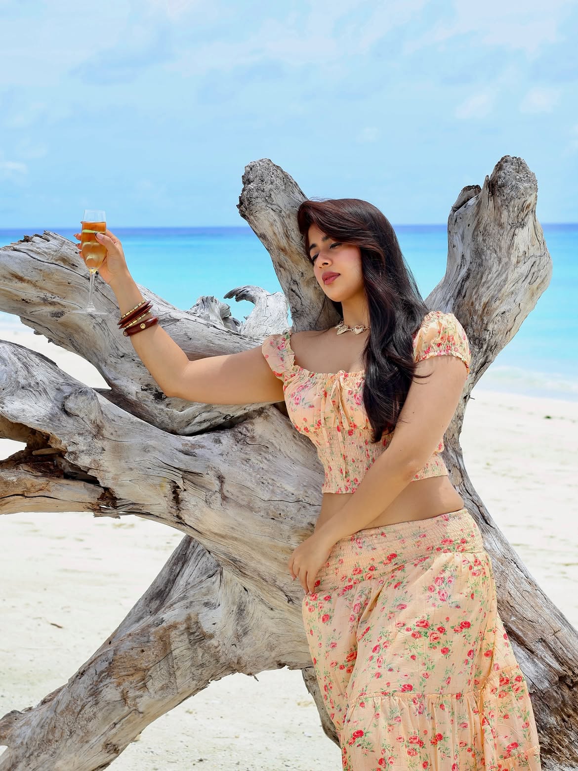 Nikita Sharma Raises A Glass In Floral Beachwear