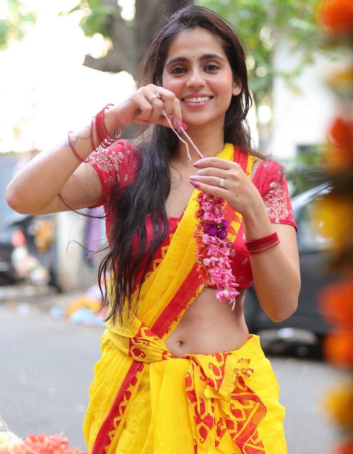 Rose Sardana Poses In A Yellow Saree With Blooms