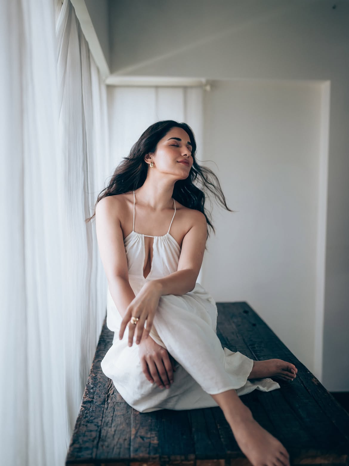 Ruhani Sharma Relaxed Pose In Flowing White Outfit