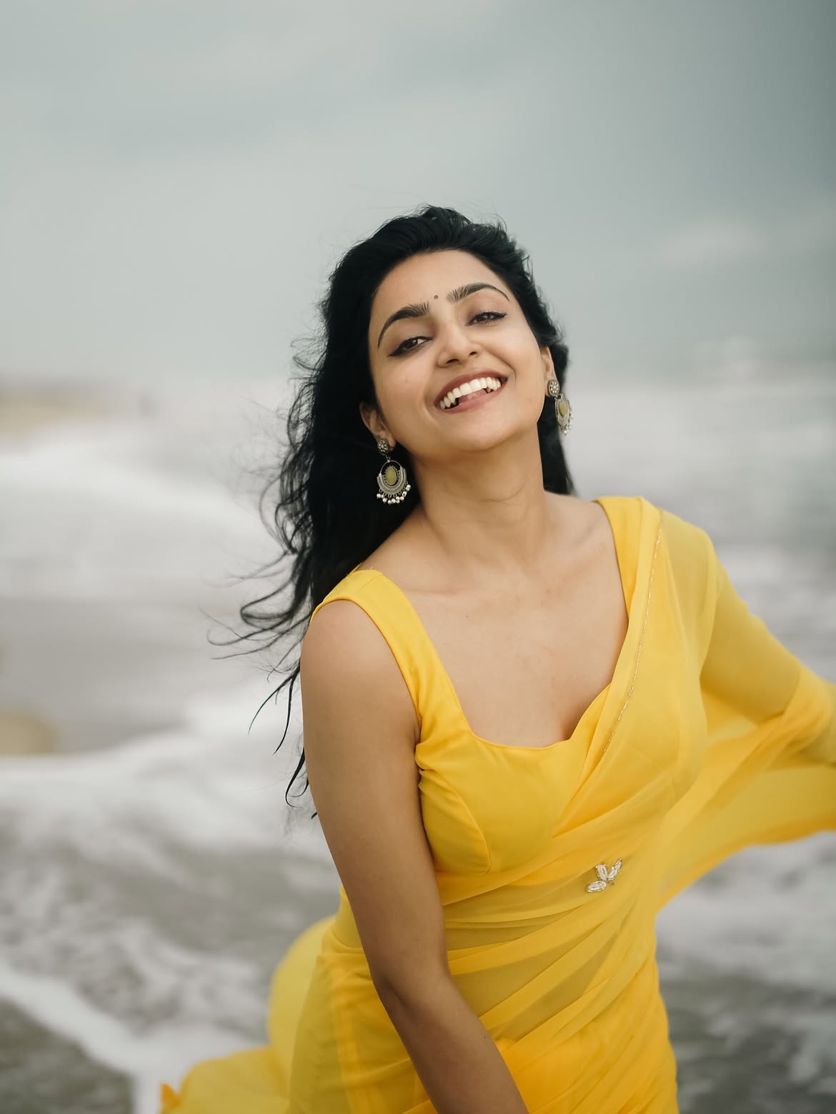 Avantika Mishra Smiling In Yellow Saree By Ocean