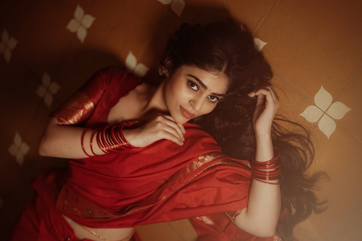 Bandhavi Sridhar Rests Her Chin In Her Red Saree