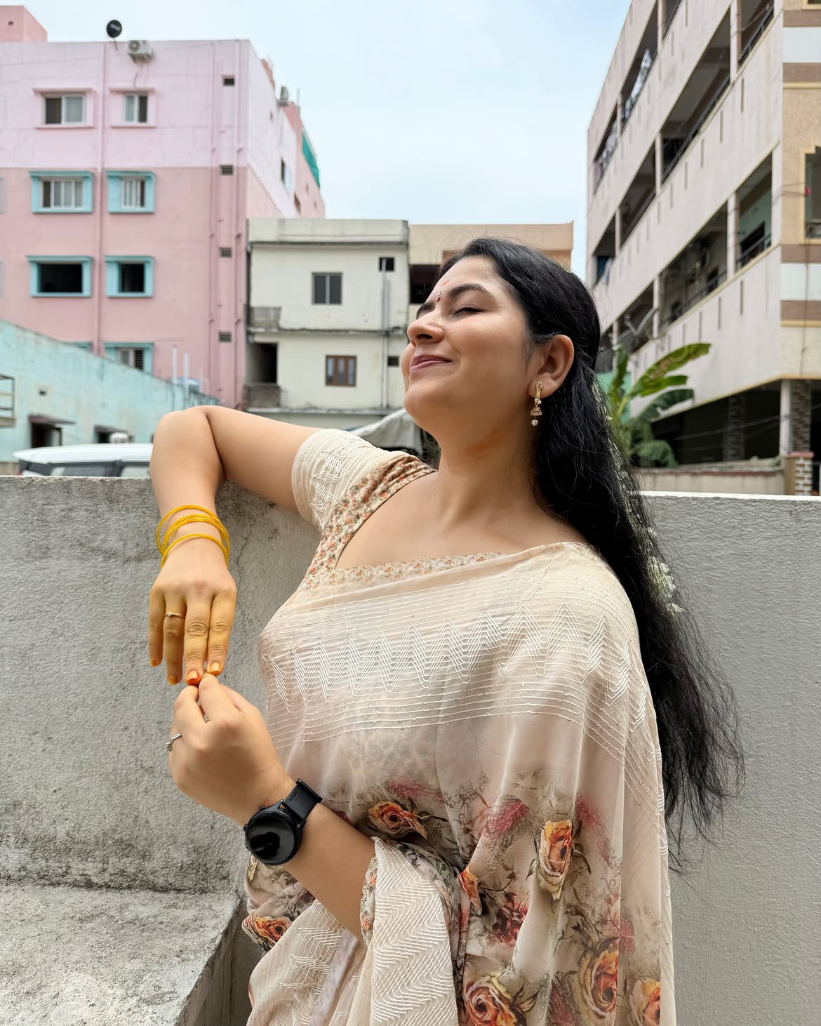 K Sudha Glowing On The Rooftop In A Floral Saree