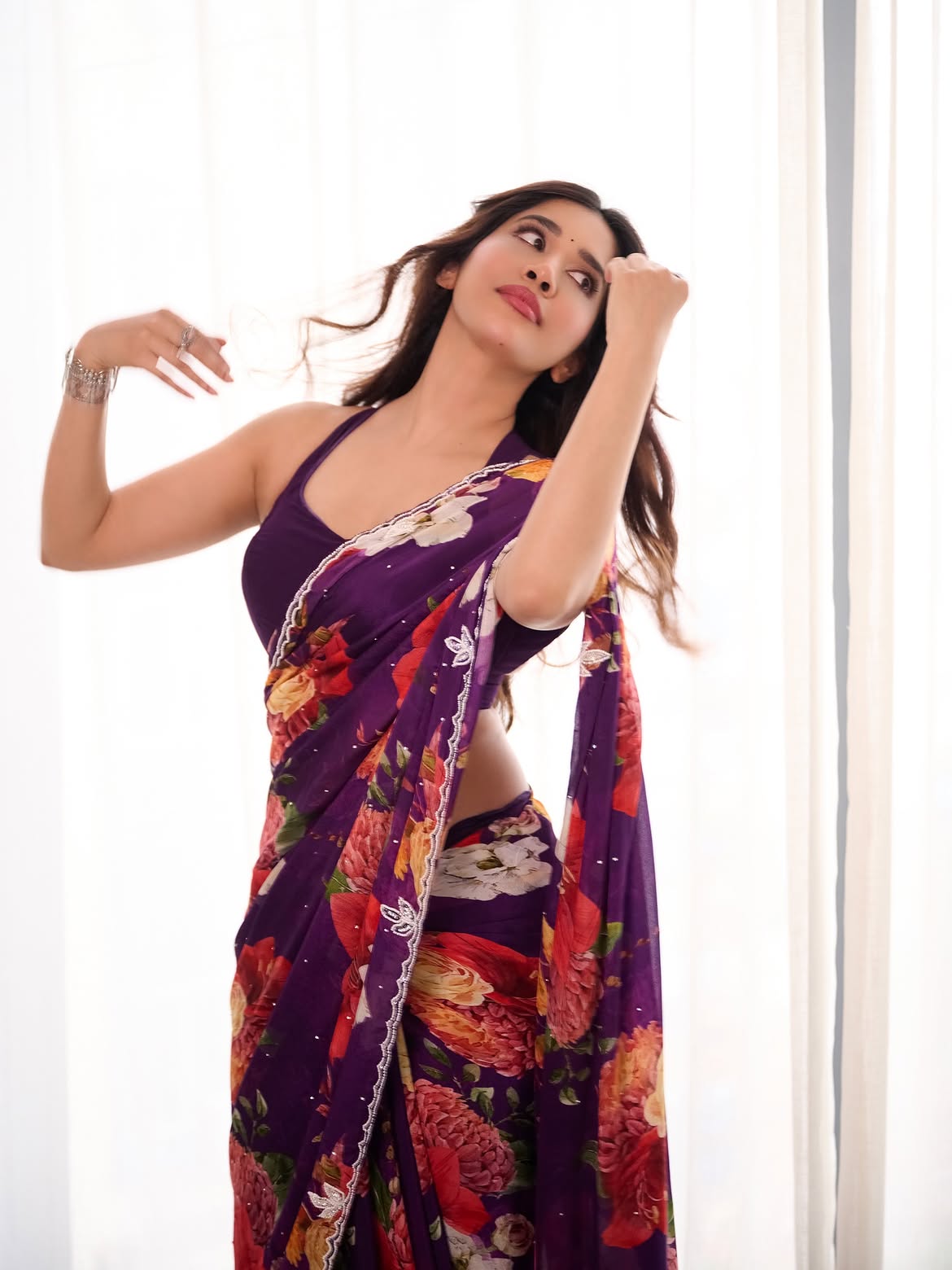 Nabha Natesh Strikes A Playful Pose By The Drape