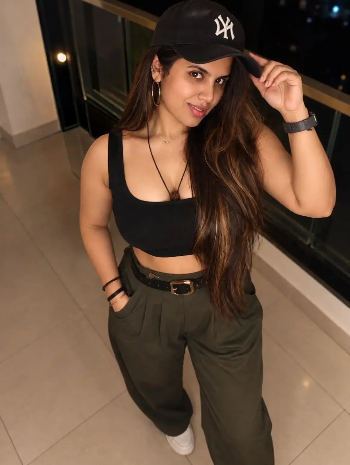 Neela Ramana Adjusts Her Cap In A Black Crop Top