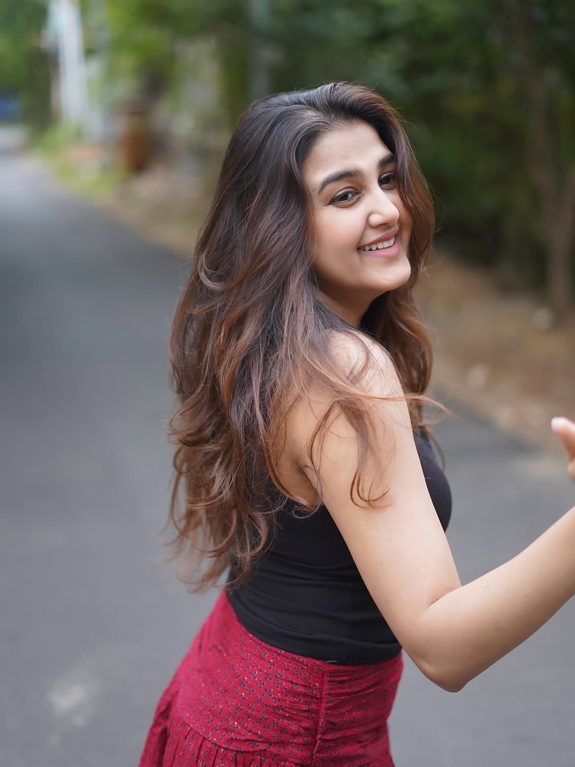 Sowmika Smiles In A Black Top And Red Mini Skirt