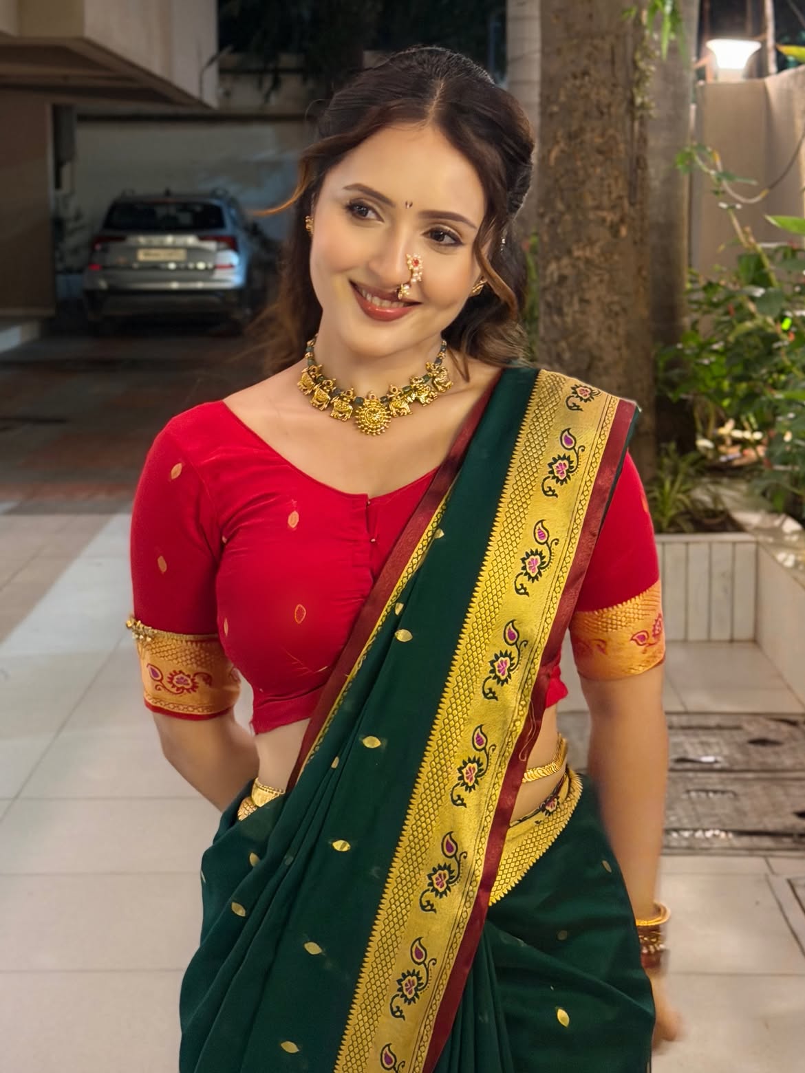 Varsha Smiles In A Green And Gold Saree Portrait