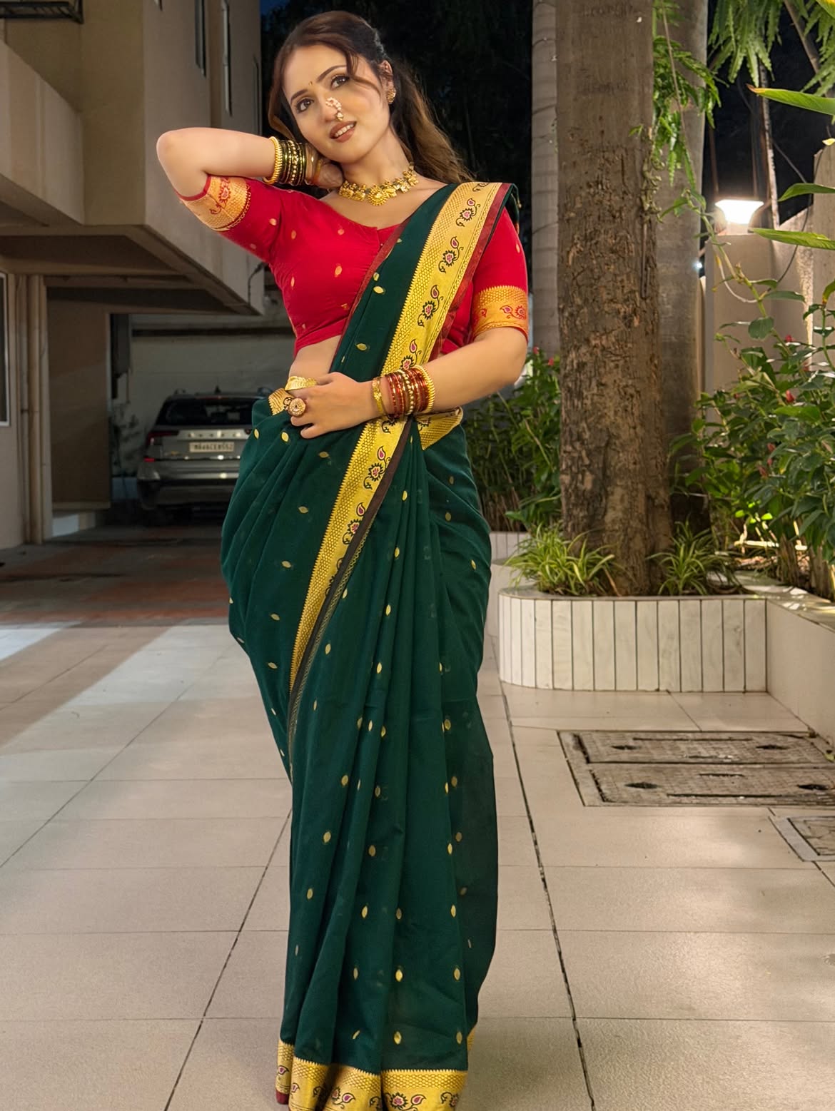 Varsha Poses With Hand On Her Hair In Saree