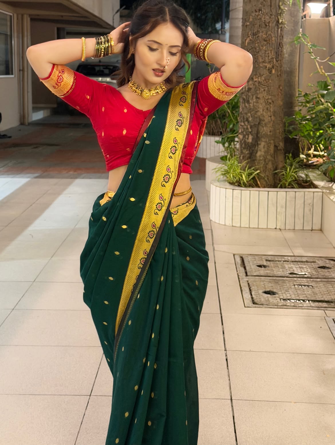 Varsha Poses In Green Saree With Raised Arms